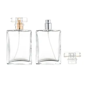 Detailed close-up of clear glass refillable perfume bottles with fine mist sprayers.