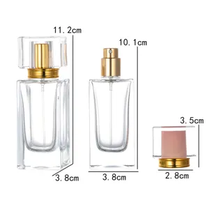 Clear glass perfume bottle 50ml with crystal cap and gold spray nozzle detail view.
