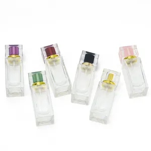 Square glass perfume bottle detail with colorful crystal cap and spray nozzle for cosmetics
