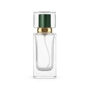 Close-up detail of square clear glass perfume bottle with crystal cap and golden spray pump.