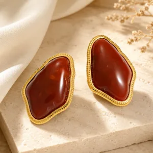 Close-up view of vintage irregular geometric resin stud earrings with golden textured edge