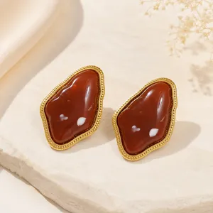 Detail view of irregular geometric resin stud earrings in retro gold Maillard style