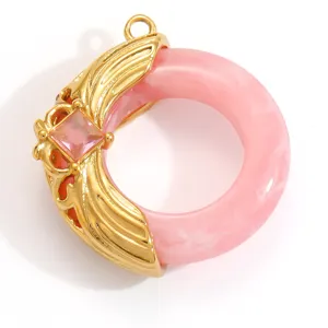 Detail view of pink resin ring pendant with gold-plated metal and square gemstone