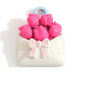 Detail of sweet flower bouquet in an envelope pendant with pink roses and bow decoration
