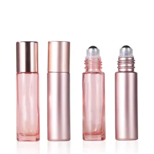 Detailed view of rose gold essential oil roller bottle feature smooth metal cap and clear glass.
