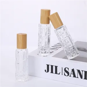 Vue détaillée de flacons à bille en verre transparent avec capuchons en bois naturels.