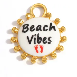 Detail macro view of a gold stainless steel Beach Vibes pendant with white enamel center