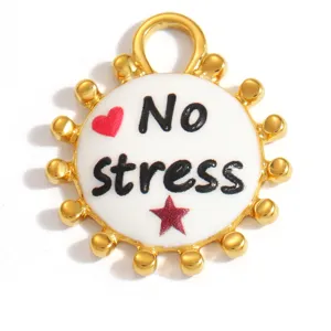 Detailed view of white enamel 'No stress' pendant with gold-plated beaded edge