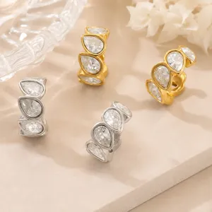Close-up of waterdrop-shaped zircon pave ear cuffs in gold and silver stainless steel.