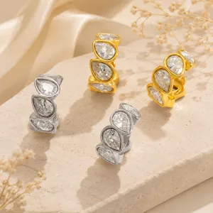 Detailed macro view of pear-shaped zircon studded ear cuffs in gold and silver finish