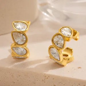 Macro detail of gold plated stainless steel ear cuff with water drop shaped clear zircons