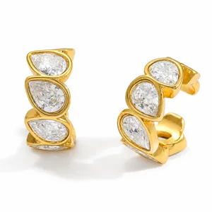 Detail macro view of gold-plated stainless steel ear cuffs with teardrop-shaped zircon