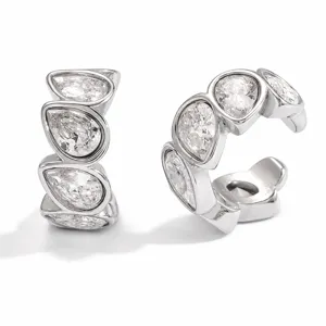 Elegant detail view of silver stainless steel ear cuffs with teardrop-shaped clear zircons.