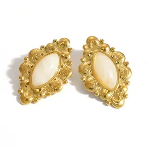 Detailed view of vintage golden titanium steel stud earrings with oval resin inlay on white