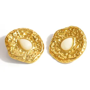 Detailed macro view of vintage irregular texture earrings with resin inlay