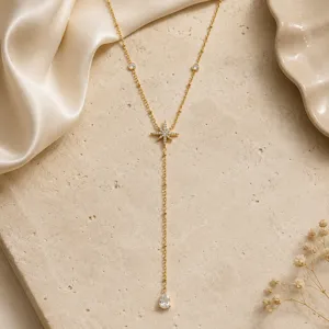 Macro view of gold plated Y-necklace featuring star pendant and teardrop zircon.