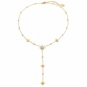 Detail of gold-plated stainless steel Y-necklace with pavé eight-pointed star pendants.