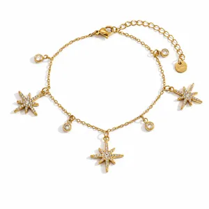 Detailed shot of 18k gold-plated bracelet featuring crystal eight-pointed stars