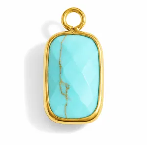 Detailed view of a faceted turquoise stone pendant set in a golden stainless steel frame
