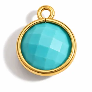 Detailed view of a circular gold stainless steel pendant featuring a faceted turquoise stone