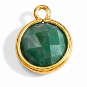 Macro view of a circular faceted green natural stone pendant in a gold steel frame