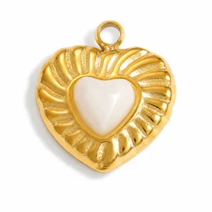 Detail of gold-plated stainless steel heart pendant with white natural stone inlay