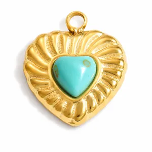 Detail view of heart-shaped stainless steel gold pendant with turquoise natural stone