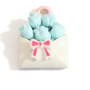 Detailed macro shot of the pastel blue rose bouquet charm with a pink ribbon bow