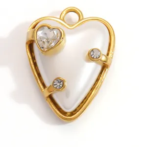 Close-up detail of a white drip oil heart pendant with golden frame and sparkling crystals