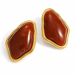 Close-up of vintage irregular geometric resin stud earrings in amber brown