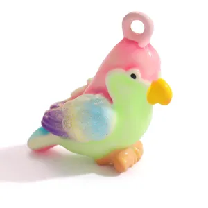 Detailed close-up view of a colorful parrot charm featuring iridescent glitter wings