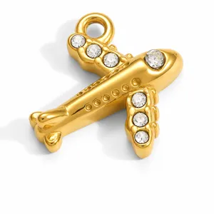 Detailed view of a polished gold-plated airplane charm with sparkling crystal inlay