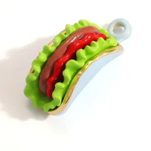Detailed macro view of a colorful hot dog shaped DIY pendant with glossy enamel finish