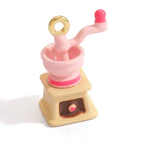 Detailed view of a sweet pink miniature coffee grinder charm for DIY jewelry design
