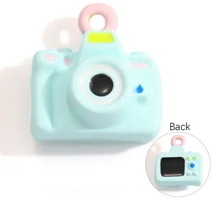Front and back detail view of a cute light blue camera shaped resin DIY charm pendant