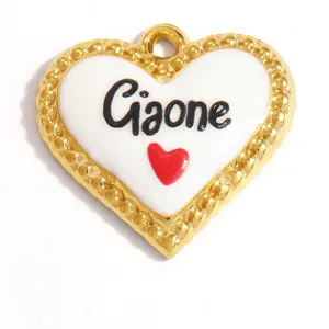 Close-up view of gold heart pendant with Ciaone Italian text and red heart detail