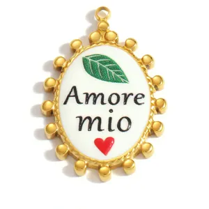 Detail of gold stainless steel oval pendant with Amore mio and leaf heart