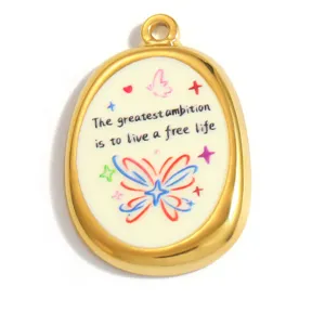 Detailed macro shot of an oval gold pendant with a butterfly and English quote