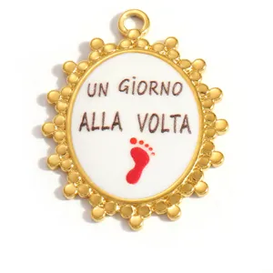 Close-up detail of gold stainless steel oval pendant with Italian text and footprint