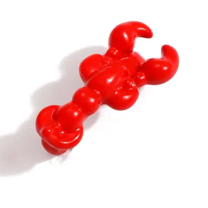 Detailed view of a shiny red lobster shoe charm for personalized footwear accessories