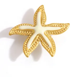 Detailed view of a gold stainless steel starfish shoe charm with white enamel finish