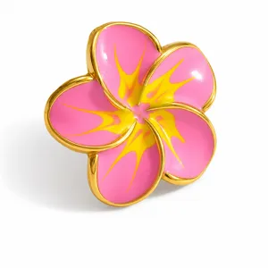 Close-up of a pink and yellow enamel plumeria flower shoe charm for clogs shoes