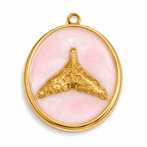 Detail view of pink marbled enamel whale tail pendant in gold stainless steel