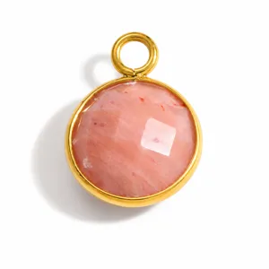 Close-up of a pink faceted natural stone pendant with gold-plated stainless steel bezel.