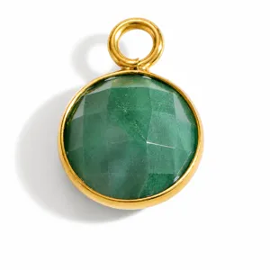 Close-up detail of a round faceted green natural stone pendant with gold steel frame