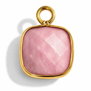 Close-up of square pink natural stone pendant with faceted surface and gold frame.