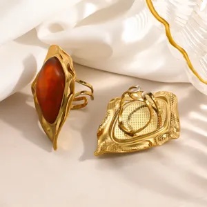 Detailed view of vintage irregular gold-plated stainless steel ring with amber resin
