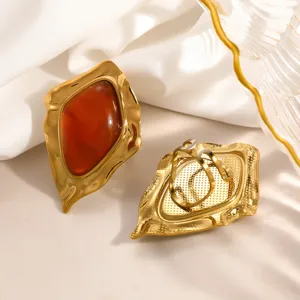 Detail showing texture of vintage irregular geometric resin earrings in gold steel
