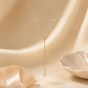 Macro view of gold-plated star Y-necklace with sparkling pear-cut zirconia pendant