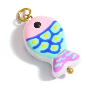 Close-up detail of a colorful handmade lampwork glass fish pendant for DIY jewelry design